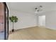 Bright living room with hardwood floors, neutral walls, ceiling fan, and sliding glass doors to a balcony at 3151 Soaring Gulls Dr # 1179, Las Vegas, NV 89128