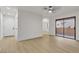 Bright living room features hardwood floors, neutral walls, a ceiling fan, and sliding glass door at 3151 Soaring Gulls Dr # 1179, Las Vegas, NV 89128