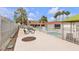 Community pool area with picnic table, mature landscaping, and lounge chairs in a relaxing setting at 3151 Soaring Gulls Dr # 1179, Las Vegas, NV 89128