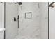 A modern bathroom features a shower with marble-look tile and black hardware at 3151 Soaring Gulls Dr # 1179, Las Vegas, NV 89128