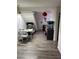 Spacious hallway with laminate flooring, leading to various rooms and featuring a staircase in the background at 4017 Edgeford Pl, Las Vegas, NV 89102
