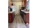 Traditional kitchen with wood cabinets, appliances, and laminate flooring at 4017 Edgeford Pl, Las Vegas, NV 89102