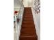 Elegant wooden staircase with white railing, ascending to the upper level of the home at 4017 Edgeford Pl, Las Vegas, NV 89102