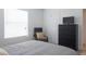 Bedroom featuring a comfy chair, black dresser with TV, and bright natural light at 4200 S Valley View Blvd # 3053, Las Vegas, NV 89103