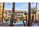 Inviting community pool area featuring palm trees, a rock waterfall, and comfortable lounge chairs at 4200 S Valley View Blvd # 3053, Las Vegas, NV 89103