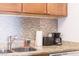 Close-up of kitchen counter showcasing granite countertops, mosaic backsplash, and stainless steel sink at 4200 S Valley View Blvd # 3053, Las Vegas, NV 89103