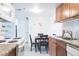 Well-lit kitchen featuring stainless steel appliances, wooden cabinetry, and cozy dining area with a dark table at 4200 S Valley View Blvd # 3053, Las Vegas, NV 89103