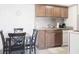 Bright kitchen featuring stainless steel appliances, wooden cabinetry, and a cozy dining area at 4200 S Valley View Blvd # 3053, Las Vegas, NV 89103