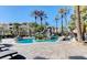 Inviting community pool with a rock waterfall feature, palm trees, and plenty of seating at 4200 S Valley View Blvd # 3053, Las Vegas, NV 89103