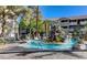 A resort-style pool with palm trees, rock features, and plenty of lounge chairs for relaxation at 4200 S Valley View Blvd # 3053, Las Vegas, NV 89103