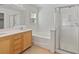 Bright bathroom featuring dual sinks, bathtub, and a separate glass-enclosed shower at 4905 Apache Valley Ave, Las Vegas, NV 89131
