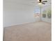 Spacious bedroom with carpet, ceiling fan, neutral paint, and multiple windows at 4905 Apache Valley Ave, Las Vegas, NV 89131