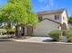 Inviting two-story home with a spacious driveway, a large two-car garage and mature trees at 4905 Apache Valley Ave, Las Vegas, NV 89131