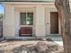 Inviting porch with stone landscaping, a front-facing window, a dark brown entry door, and seating for outdoor relaxation at 4905 Apache Valley Ave, Las Vegas, NV 89131
