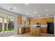 Bright kitchen with wooden cabinets, a breakfast bar, stainless steel appliances, and an outdoor view at 4905 Apache Valley Ave, Las Vegas, NV 89131