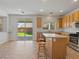 Eat-in kitchen with access to backyard, wood cabinets, island with seating, and stainless appliances at 4905 Apache Valley Ave, Las Vegas, NV 89131