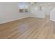 Bright living room with wood-look floors, neutral walls, and large windows that provide natural light at 4905 Apache Valley Ave, Las Vegas, NV 89131
