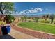 Expansive backyard features lush grass, desert landscaping, and a stunning mountain view at 522 Via Ventana Dr, Mesquite, NV 89027