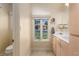Bright bathroom with a large window, vanity, and soft, natural light at 522 Via Ventana Dr, Mesquite, NV 89027