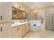 Main bathroom features dual sinks, soaking tub, decorative lighting, and tiled walk-in shower at 522 Via Ventana Dr, Mesquite, NV 89027