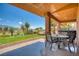 Covered patio with comfortable seating, perfect for enjoying the outdoor views and hot tub at 522 Via Ventana Dr, Mesquite, NV 89027