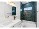 This stylish bathroom features a vessel sink, modern lighting, and decorative herringbone tile in the shower at 5225 Villa Dante Ave, Las Vegas, NV 89141