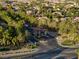 An aerial view of the neighborhood entrance with a decorative gate and lush trees surrounding the entry area at 5225 Villa Dante Ave, Las Vegas, NV 89141