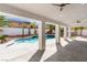 Covered patio overlooking a backyard with a pool, spa, and desert landscaping at 5225 Villa Dante Ave, Las Vegas, NV 89141