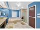 Bright bathroom featuring a soaking tub, glass shower, and dual-sink vanity at 544 N Fogg St, Las Vegas, NV 89110