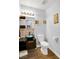 Modern powder room with stylish vanity, vessel sink, decorative mirror, and wood-look flooring at 544 N Fogg St, Las Vegas, NV 89110