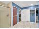 Bathroom featuring a walk-in shower, unique tile floor, and access to storage at 544 N Fogg St, Las Vegas, NV 89110