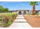 Inviting front entrance with desert landscaping and a walkway to the front door at 544 N Fogg St, Las Vegas, NV 89110