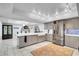 Bright kitchen features an island, stainless steel refrigerator, and gray cabinets with blue backsplash at 544 N Fogg St, Las Vegas, NV 89110