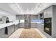 Kitchen with stainless steel appliances, gray cabinets, and tile backsplash at 544 N Fogg St, Las Vegas, NV 89110