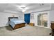 Spacious main bedroom featuring a tray ceiling, neutral carpet, and a sliding glass door at 544 N Fogg St, Las Vegas, NV 89110