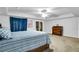 Spacious main bedroom featuring a tray ceiling, neutral carpet, and a large wooden dresser at 544 N Fogg St, Las Vegas, NV 89110