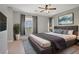 Comfortable bedroom with a large bed, a ceiling fan, and bright natural light at 626 Taliput Palm Pl, Henderson, NV 89011