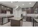 Modern kitchen with granite countertops, stainless steel appliances, and a convenient center island at 626 Taliput Palm Pl, Henderson, NV 89011