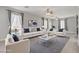 Bright living room with plush seating, a modern ceiling fan, and a stylish gray rug at 626 Taliput Palm Pl, Henderson, NV 89011