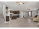 Open layout featuring wood-look floors, stainless steel appliances, and a kitchen island at 626 Taliput Palm Pl, Henderson, NV 89011