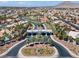 Scenic aerial view of a community entrance, showcasing lush palm trees and well-maintained landscaping at 6292 Belgium Dr, Las Vegas, NV 89122