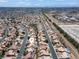 Wide aerial view of the community showcasing many homes with tile roofs and desert landscaping at 6292 Belgium Dr, Las Vegas, NV 89122