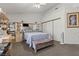 This is a view of the bedroom featuring a plush bed, coordinating furniture, and a bright window at 6292 Belgium Dr, Las Vegas, NV 89122