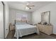 This is a view of the bedroom with a plush bed, coordinating furniture, and natural light at 6292 Belgium Dr, Las Vegas, NV 89122