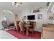 Dining room with hardwood table, seating for six, and a large bright window at 6292 Belgium Dr, Las Vegas, NV 89122