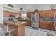 Well-equipped kitchen with stainless steel appliances, island seating, and tile flooring at 6292 Belgium Dr, Las Vegas, NV 89122