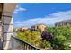 From the balcony, see the neighborhood's vibrant trees and beautiful architecture under a bright blue sky at 6402 Parrot Ridge Ct, Las Vegas, NV 89139