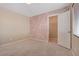 This bedroom features a geometric accent wall, neutral carpet, and a walk-in closet at 6402 Parrot Ridge Ct, Las Vegas, NV 89139