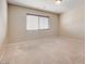 Cozy bedroom featuring a window for natural light, neutral carpet, and blank canvas at 6402 Parrot Ridge Ct, Las Vegas, NV 89139