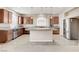 This spacious kitchen boasts stainless steel appliances, wooden cabinets, and a large central island at 6402 Parrot Ridge Ct, Las Vegas, NV 89139